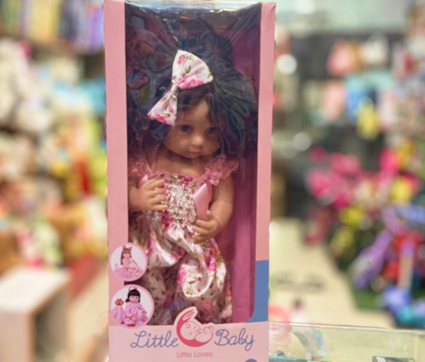 عروسک سیلیکونی دختر بچه 50 سانتی سخنگو با گل سر صورتی_عروسک